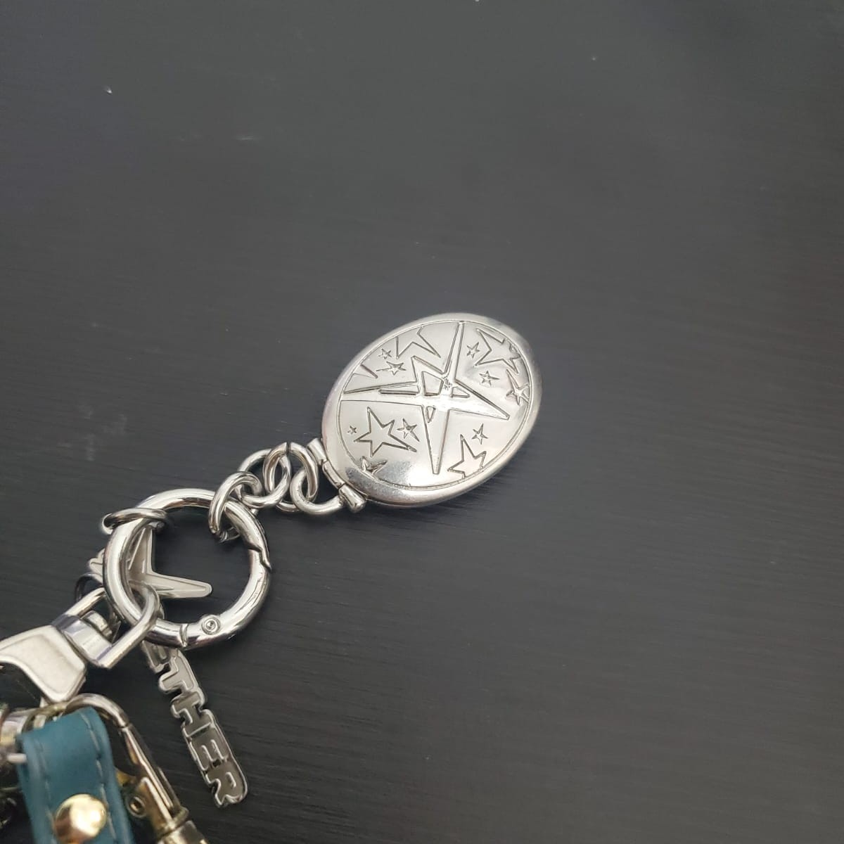 A keychain featuring a hinged locket that invites an opening and closing gesture.