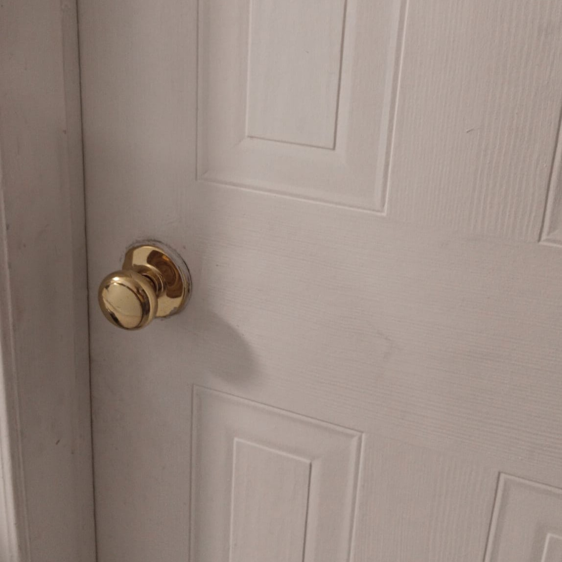 A round door knob that affords twisting to open or close a door.