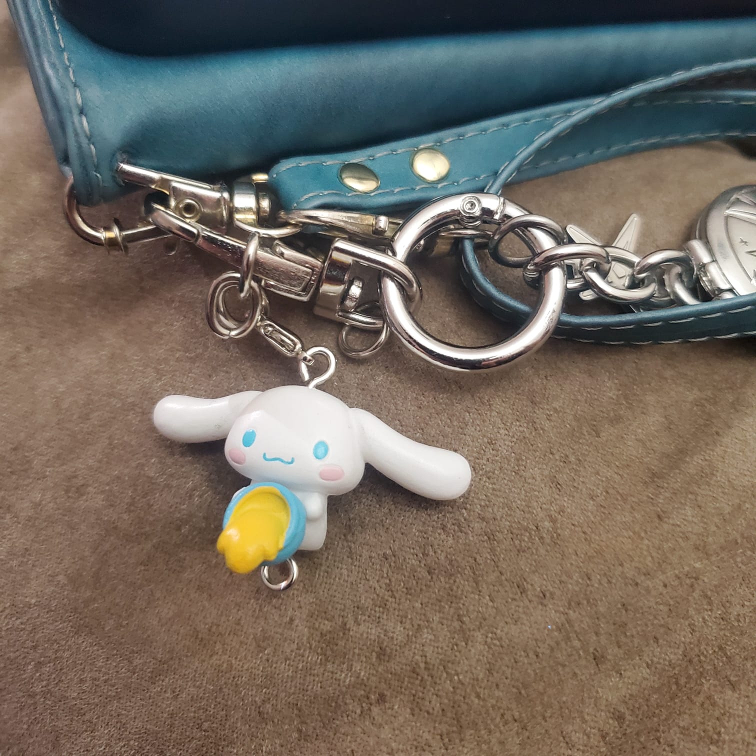 Cute Keychains on My Phone:
The small charms tapped lightly against my phone as it moved. The metal rings made clink sounds when they touched.