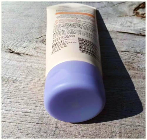 Baby skin cream with a purple cap.