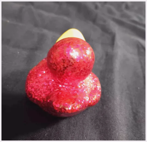 Back of a pink sparkly bathtub duck toy.