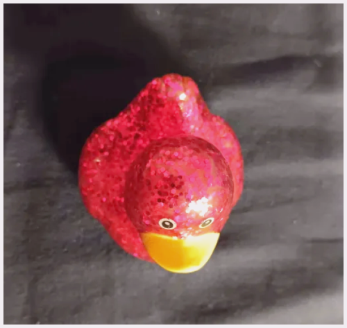Top view of a pink sparkly bathtub duck toy.