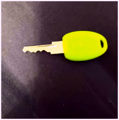 My keys to lock my bike, it's a nice neon green placed in a different angle.